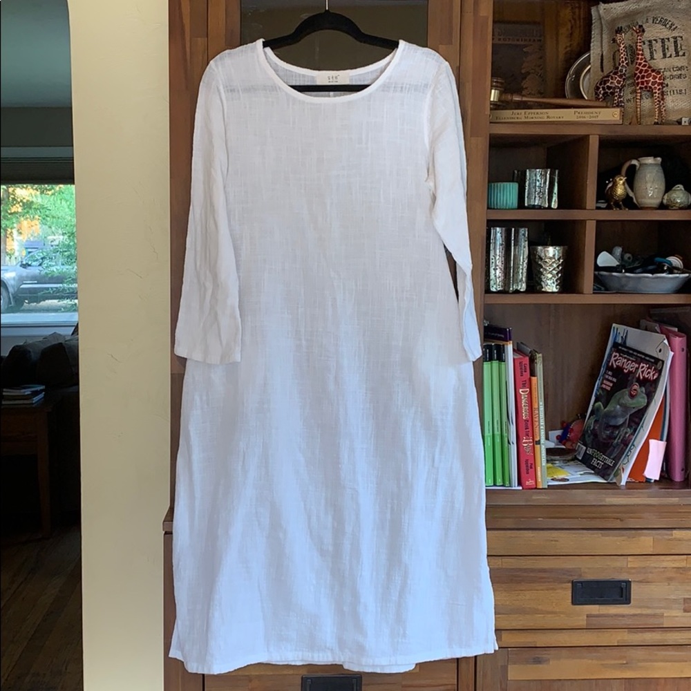 White linen-like tunic dress with pockets.